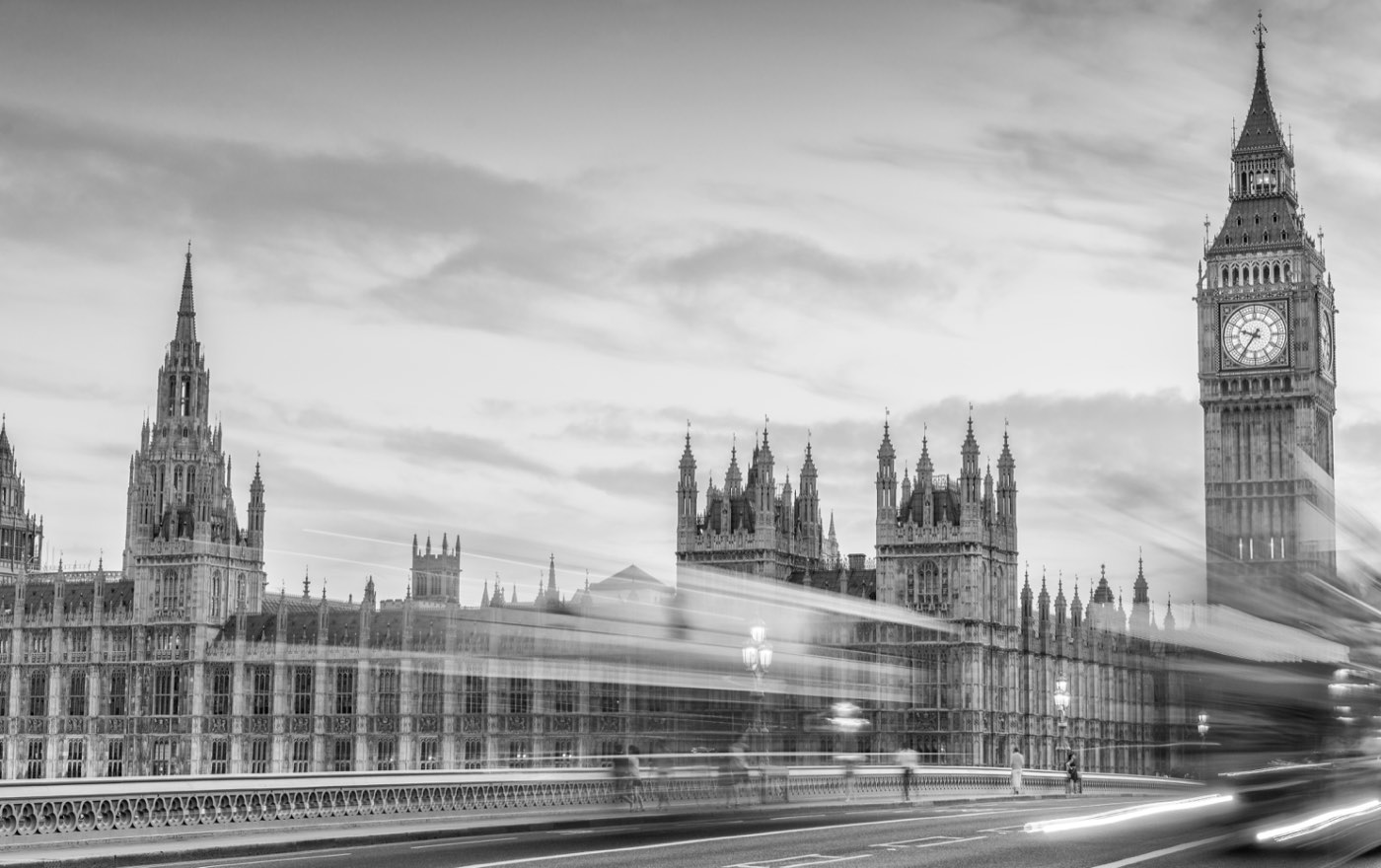 Westminster and Big Ben at dusk, traffic streaking across Westminster Bridge.