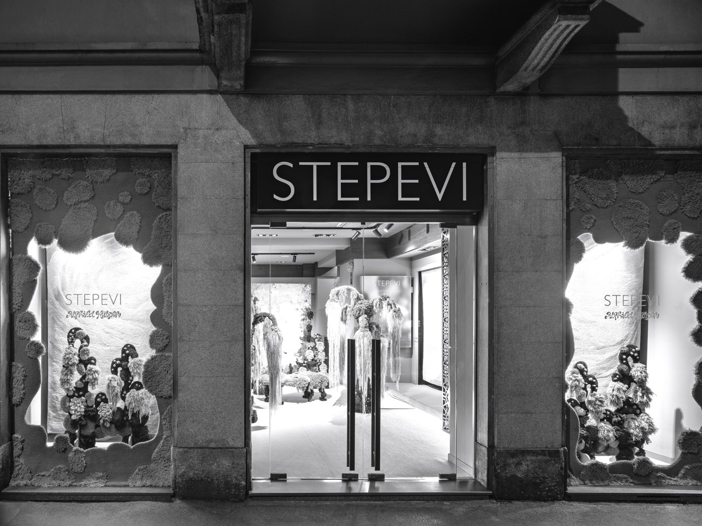 The Stepevi storefront at Milan Design Week, its windows filled with tufted textile landscapes.